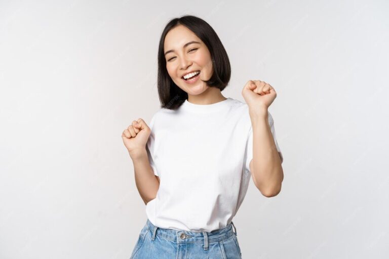 happy-dancing-korean-girl-posing-against-white-background-wearing-tshirt_1258-88991